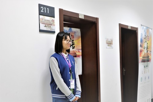 3志愿者在教室门口迎接参赛者 3志愿者在教室门口迎接参赛者