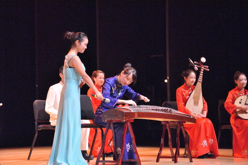 图3-主持人为观众一一介绍中国传统民族乐器 图3-主持人为观众一一介绍中国传统民族乐器